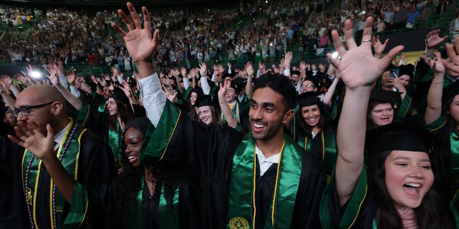 Baylor graduates doing a Sic 'Em at Commencement