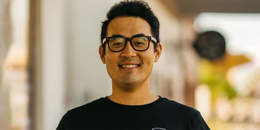 Devin Li stands outside Cha Community