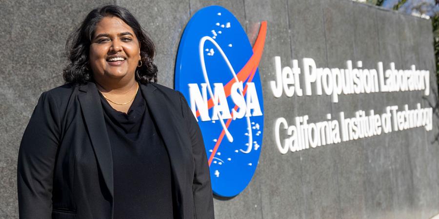 Richa Sorohi, standing outside a sign for NASA's Jet Propulsion Lab