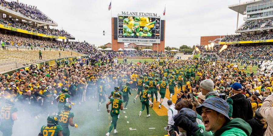 Players run onto the field at McLane Stadium