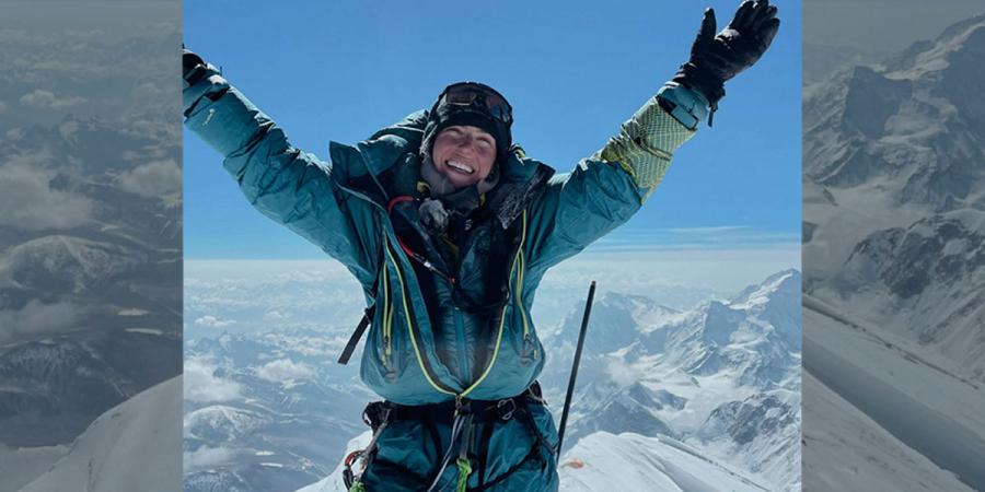 Jess Wedell stands atop Mount Everest
