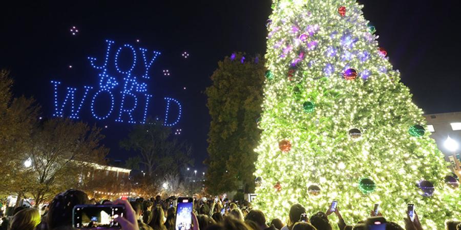 Christmas tree lit on Fountain Mall with "Joy to the World" spelled out by drones in the sky