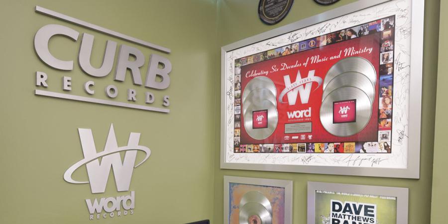 Wall displaying Curb and Word Records memorabilia