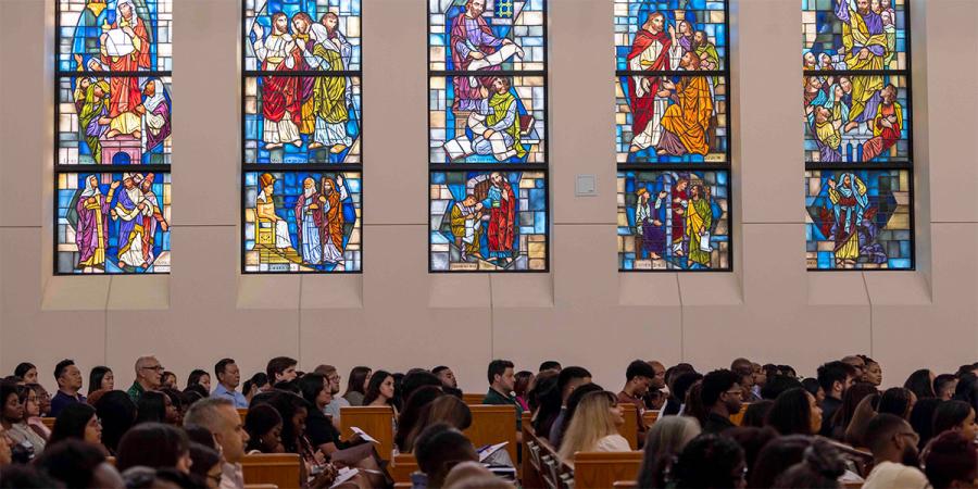 Truett students in chapel with stained glass in background