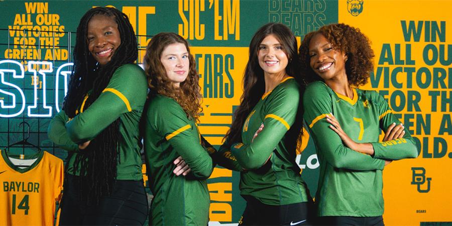 Baylor volleyball players with green and gold imagery