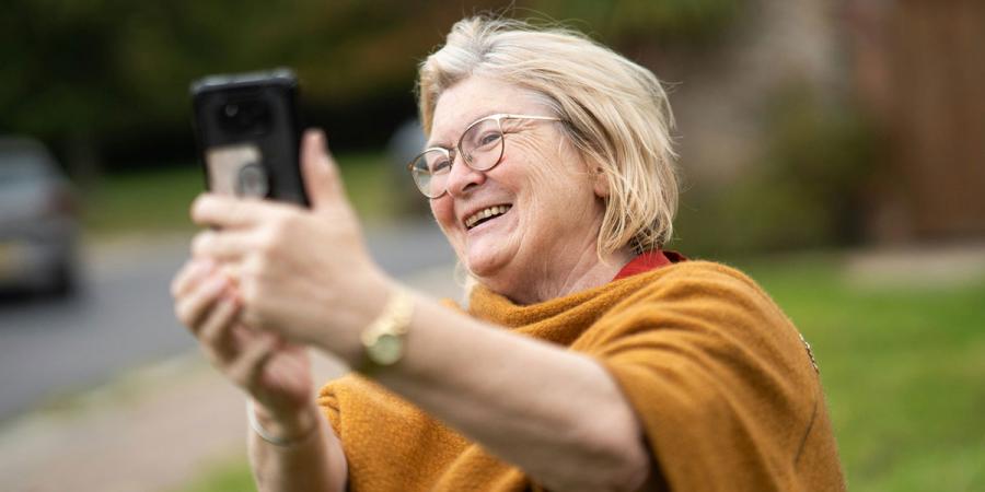 An older woman using a cell phone