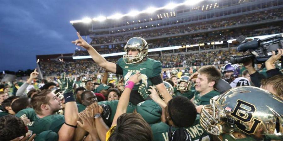 Baylor football players carry kicker Chris Callahan off the field after beating TCU