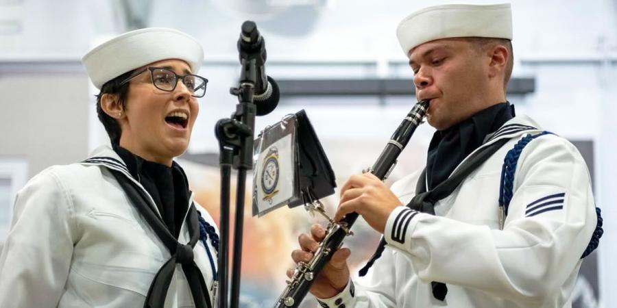 Alissa Ruth Suver (left) performing with the Navy Band Sea Chanters
