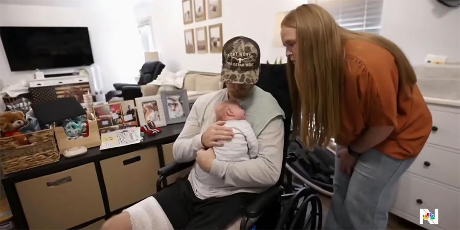 Caleb holds his son, Hudson, while Mahala looks on