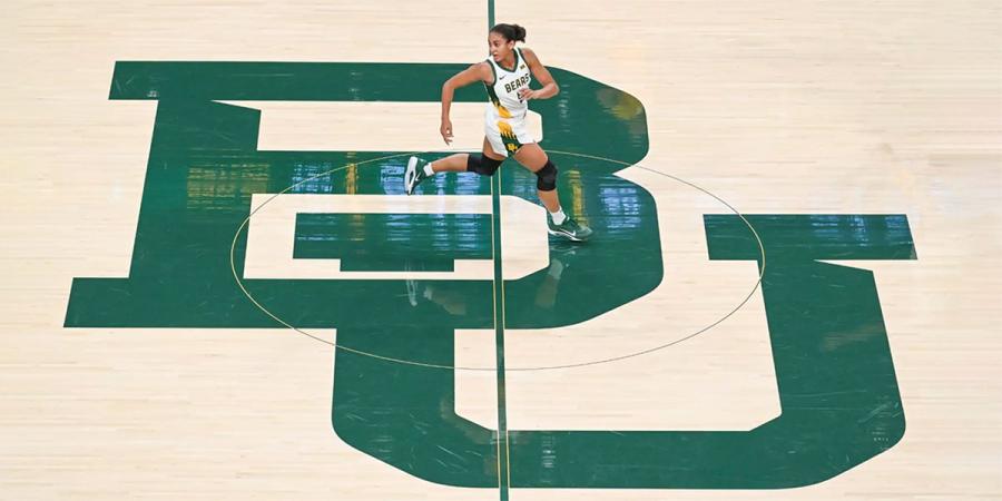 A Baylor women's basketball player runs past the BU at center court