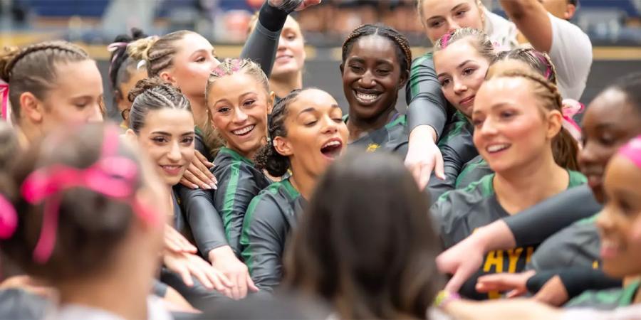 Baylor acrobatics and tumbling competitors in a team huddle