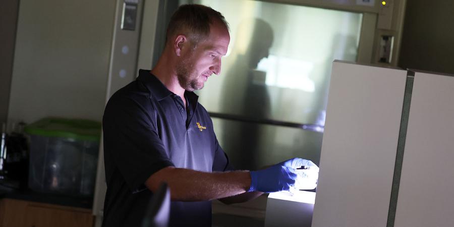 Dr. Jake Minich doing research in a lab